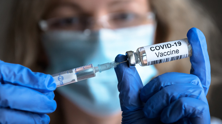 COVID-19 vaccine in a medical professional's hands.
