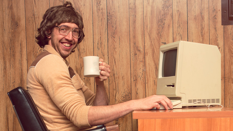 man using '80s desktop computer