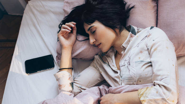 Person sleeping next to phone