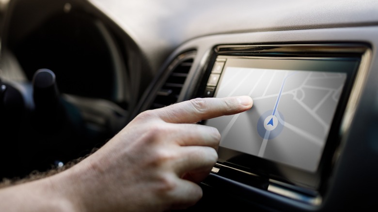 Person using car stereo touchscreen
