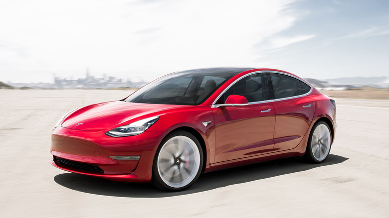 A red Tesla Model 3.