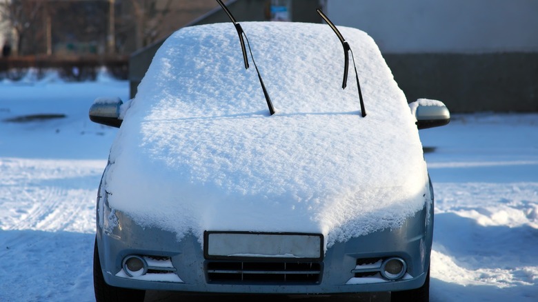 A snow-covered car
