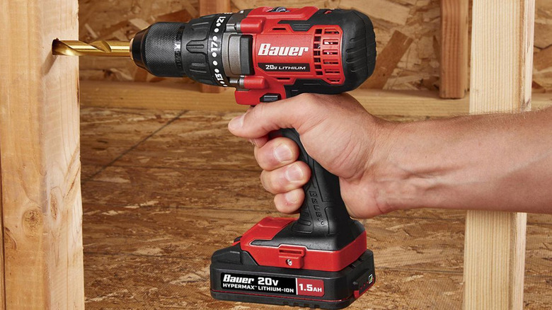 person using bauer cordless drill