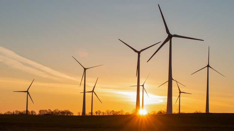 Wind turbines set against a rising sun