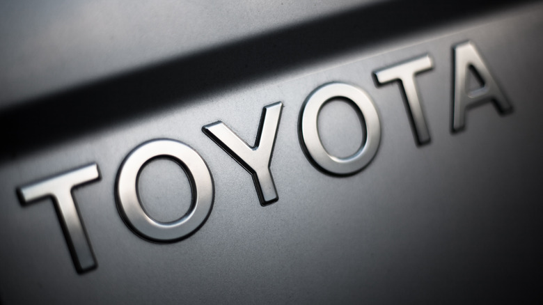 Silver Toyota name on black background